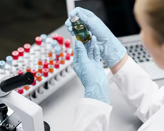 scientist examining small jar